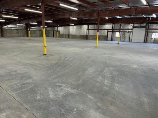interior of empty warehouse, concrete floor.